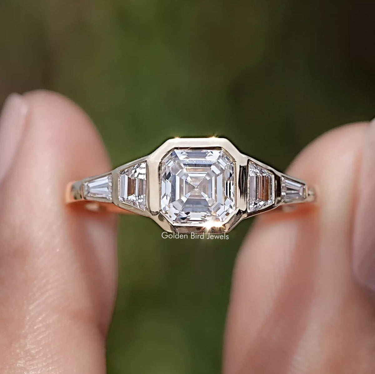 Asscher And Trapezoid Lab Diamond Five Stone Ring Between Two Fingers