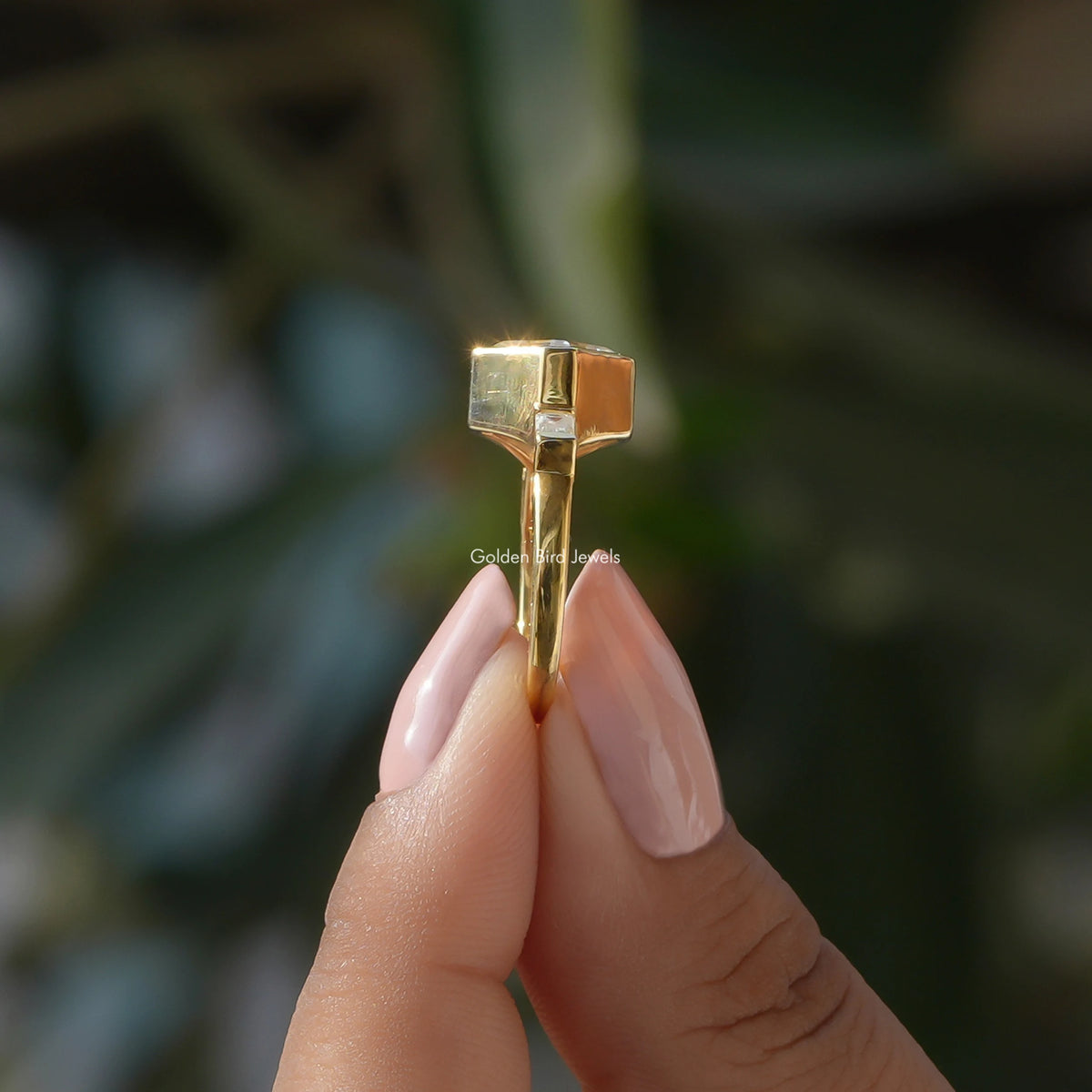 Side View of Asscher Cut Lab Diamond Three Stone Ring In two fingers
