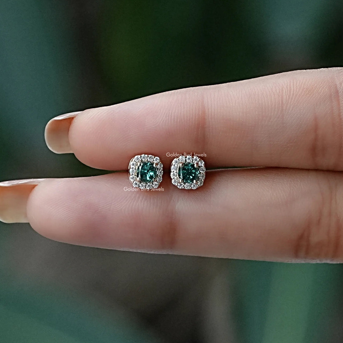 In two finger view of Stud earrings crafted in moissanite