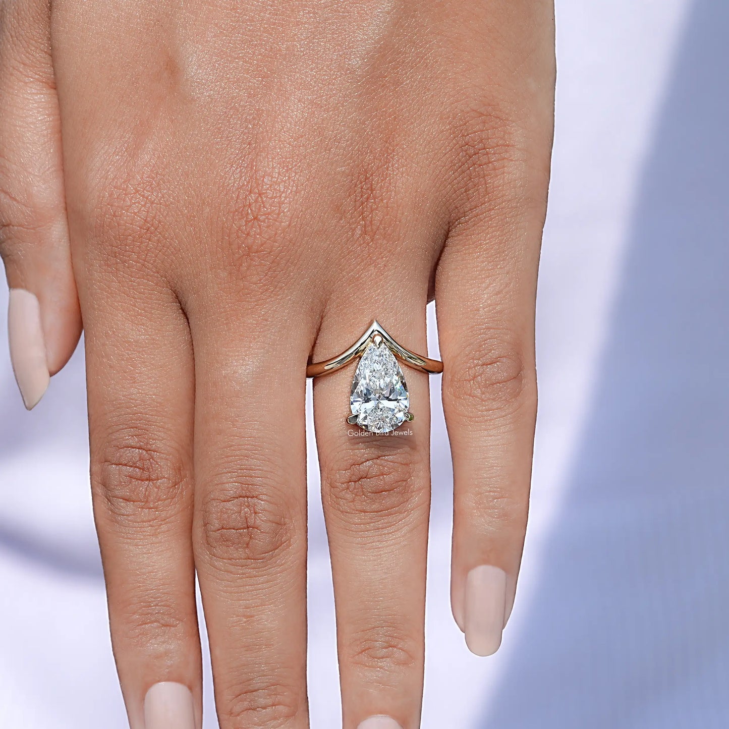 View of Pear cut lab diamond v shaped curved solitaire ring In Yellow Gold