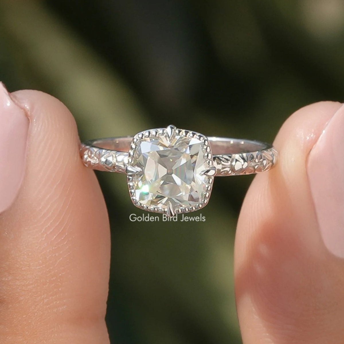 Two fingers holding the Peruzzi Cut Moissanite Solitaire Ring