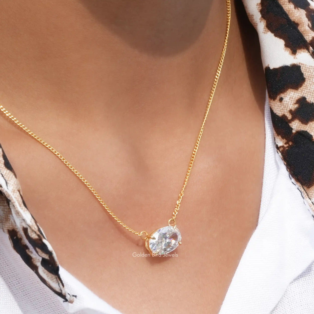 In neck view of east west crushed moissanite halo pendant