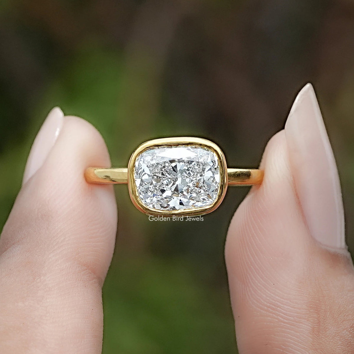 East West Cushion Cut Lab Diamond Bezel Set Ring In Two Fingers