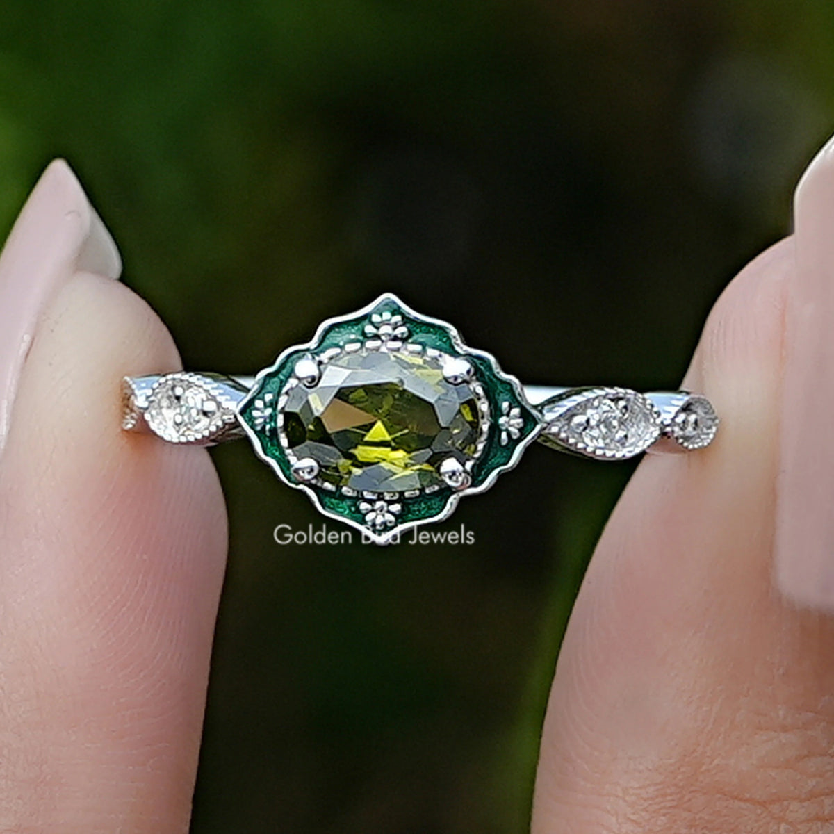 Front view of East West Oval Cut Gemstone Engagement Ring in two fingers