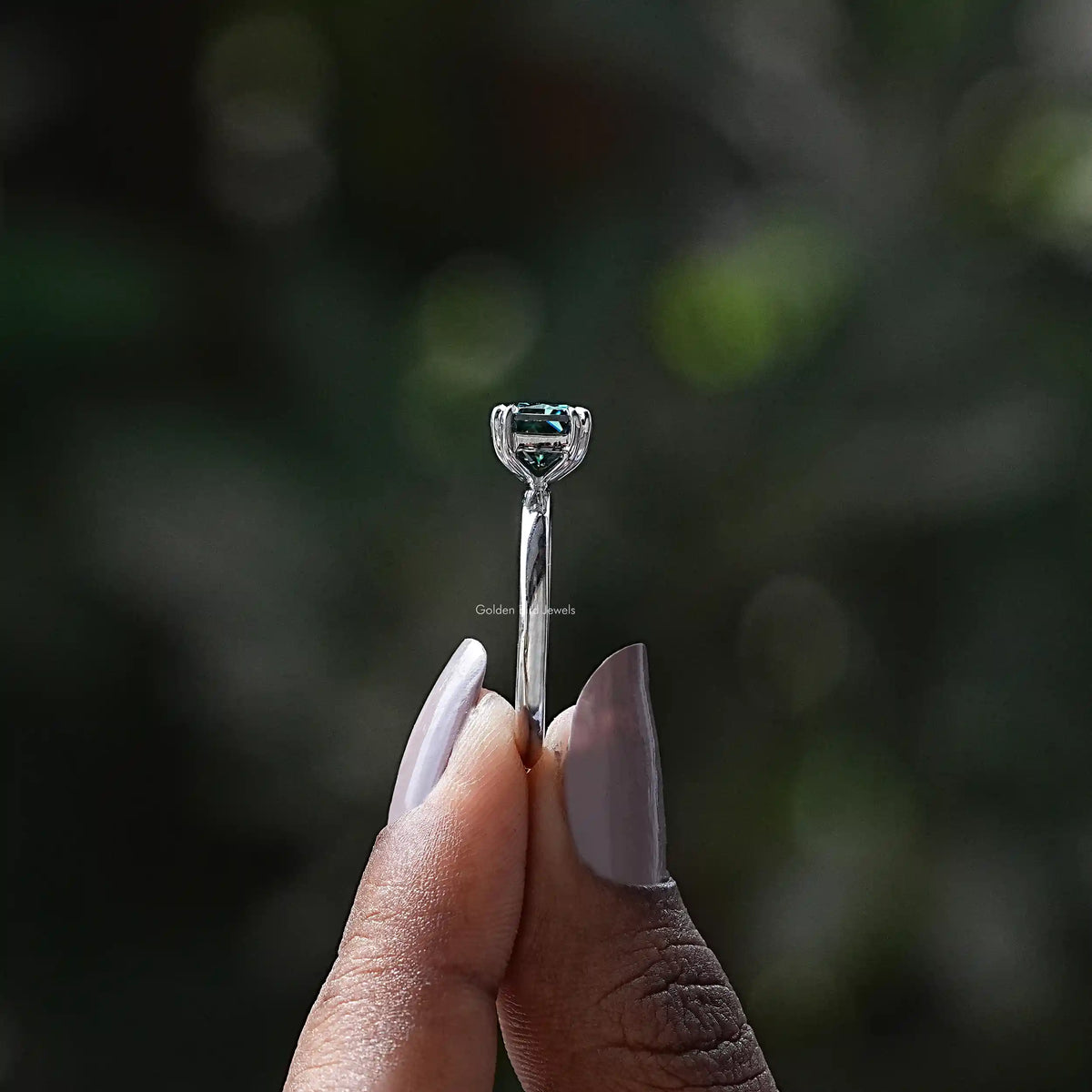 Side View of East West Radiant Cut Solitaire Ring In two fingers