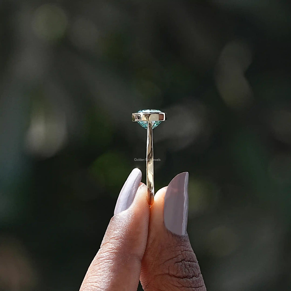 Side View of Moissanite Oval Cut East West Ring In two fingers