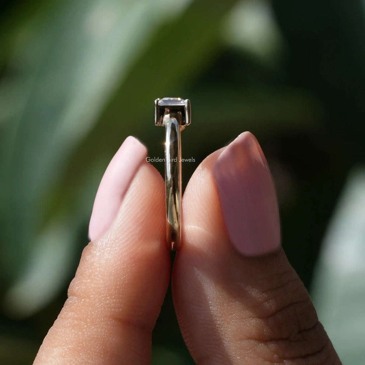 Side View of Trillion Cut Moissanite Toi Et Moi Ring In two fingers