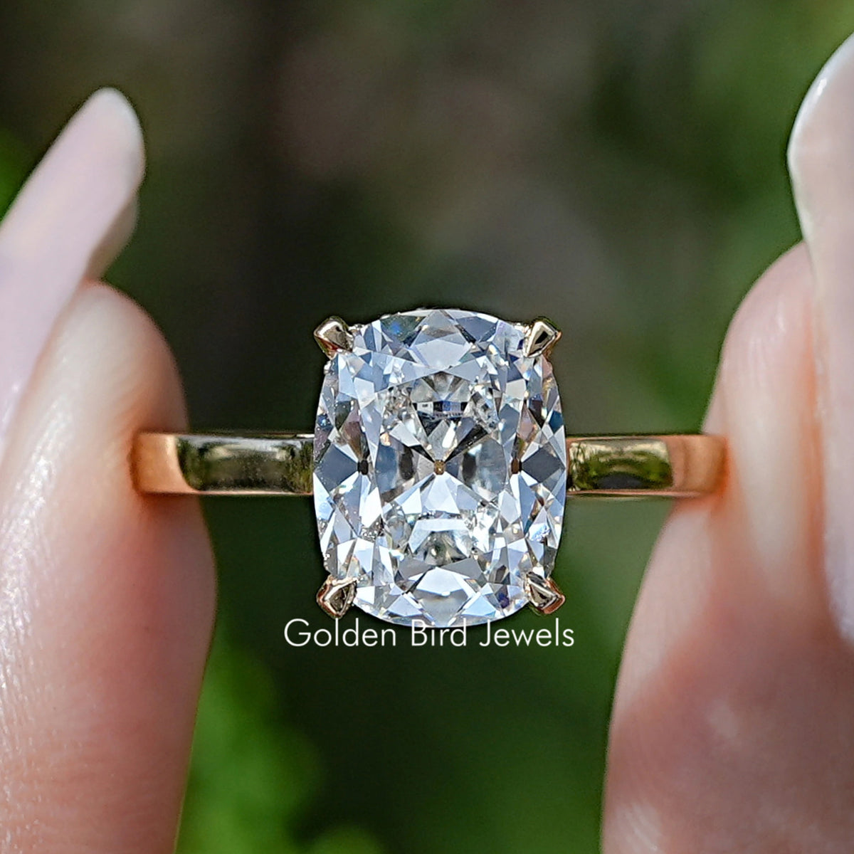 Elongated Old Mine Cushion Lab Diamond Hidden Halo Ring Held Between Fingers