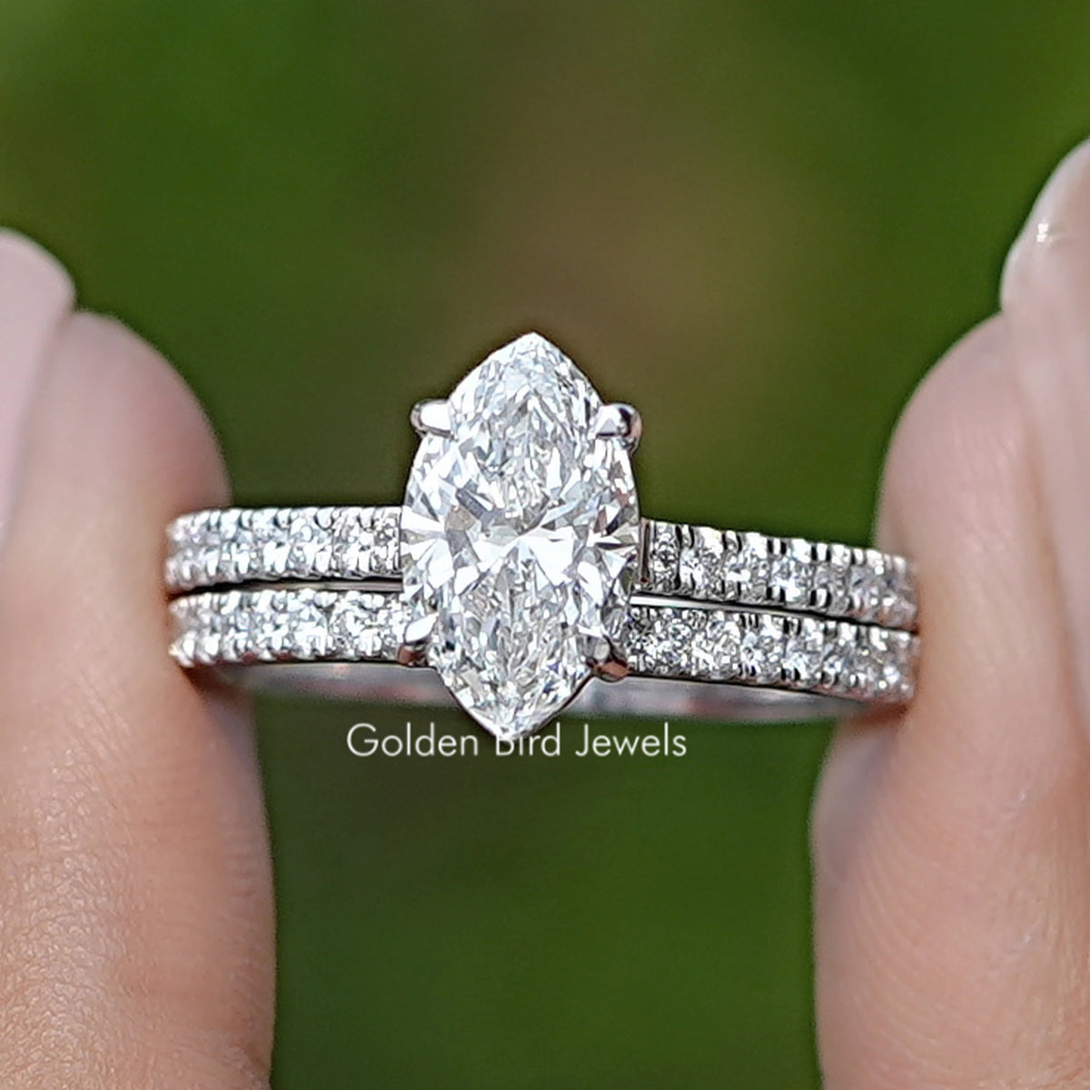 Marquise Cut Lab Grown Diamond Bridal Ring Held Between Fingers