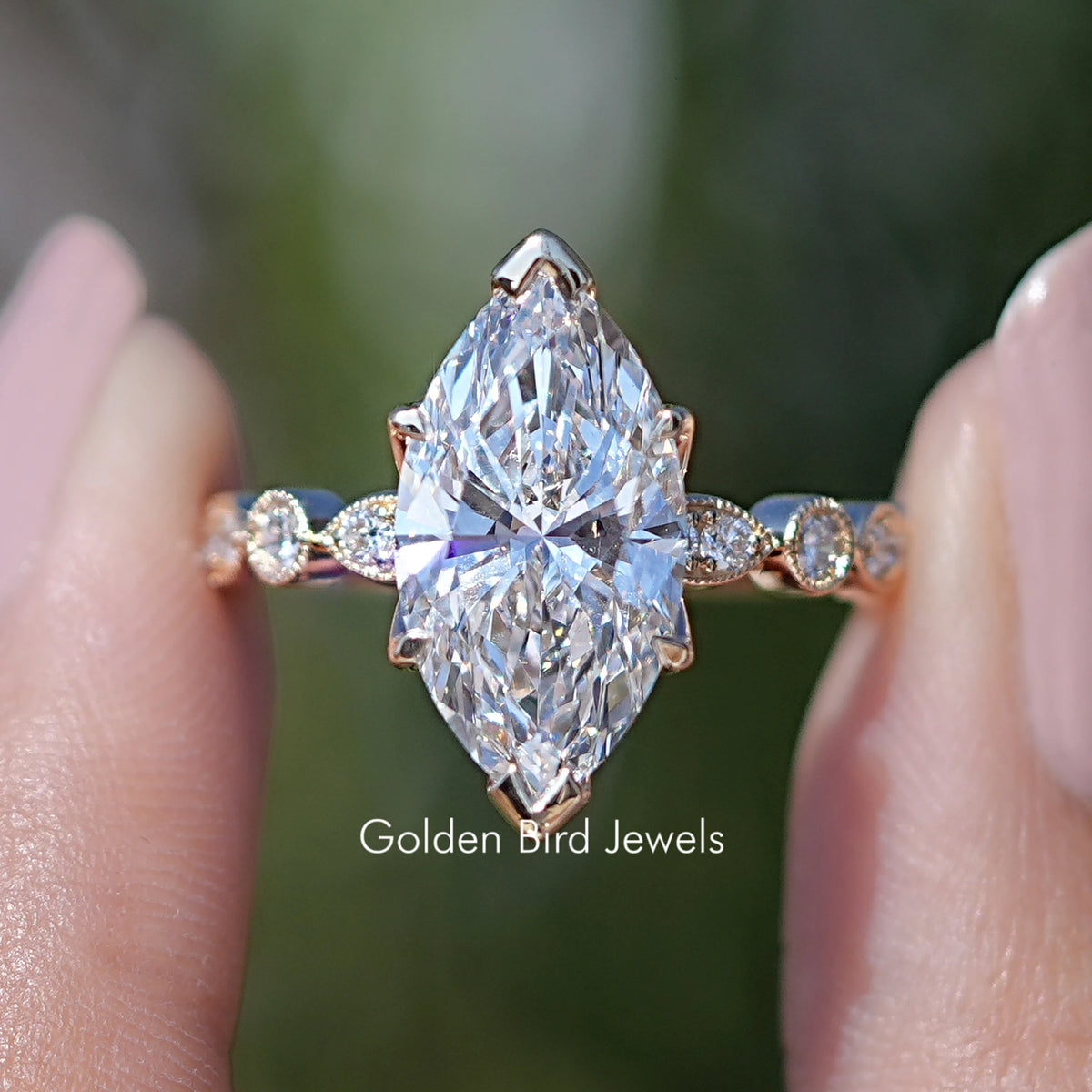 Marquise Cut Lab Diamond Accent Bridal Ring Set Held Between Fingers