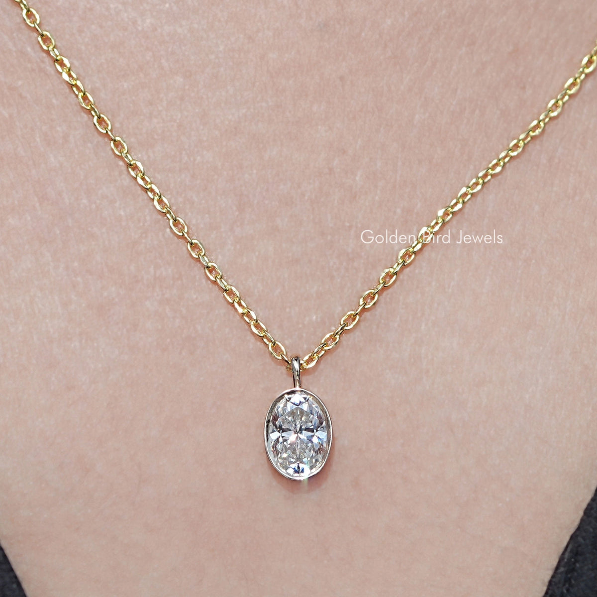 In neck View Of Bezel Set Oval Cut Moissanite Solitaire Pendant