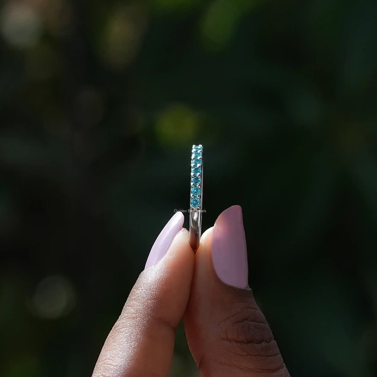 Side view of December Birthstone Blue Topaz Round Eternity Band