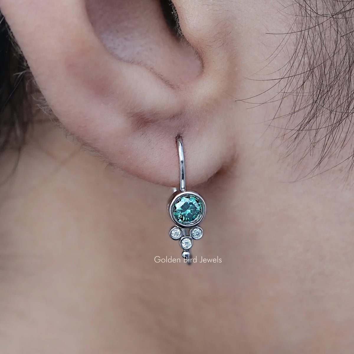 In Ear View Of Green Round Moissanite Earwire Drop Earrings in prongs setting