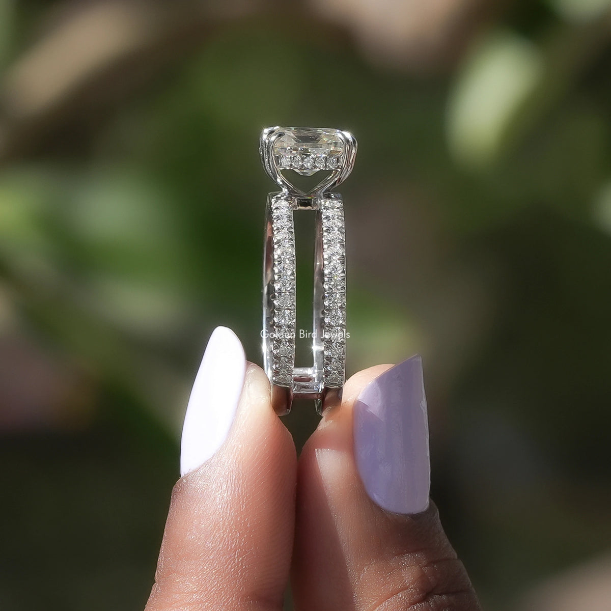 Side View of Hidden Halo Cushion Cut Moissanite Ring In two fingers