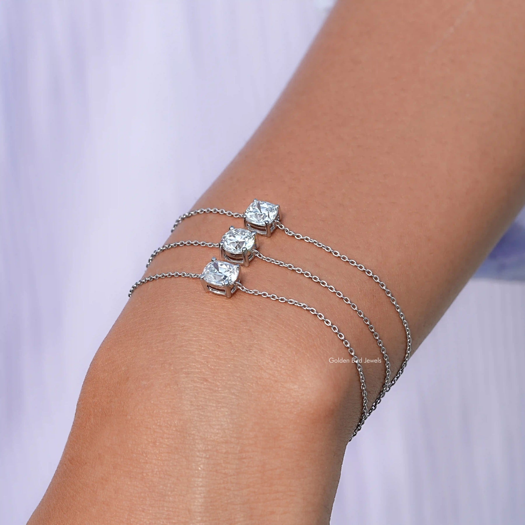 In hand showing view of Lab multi shaped bracelet