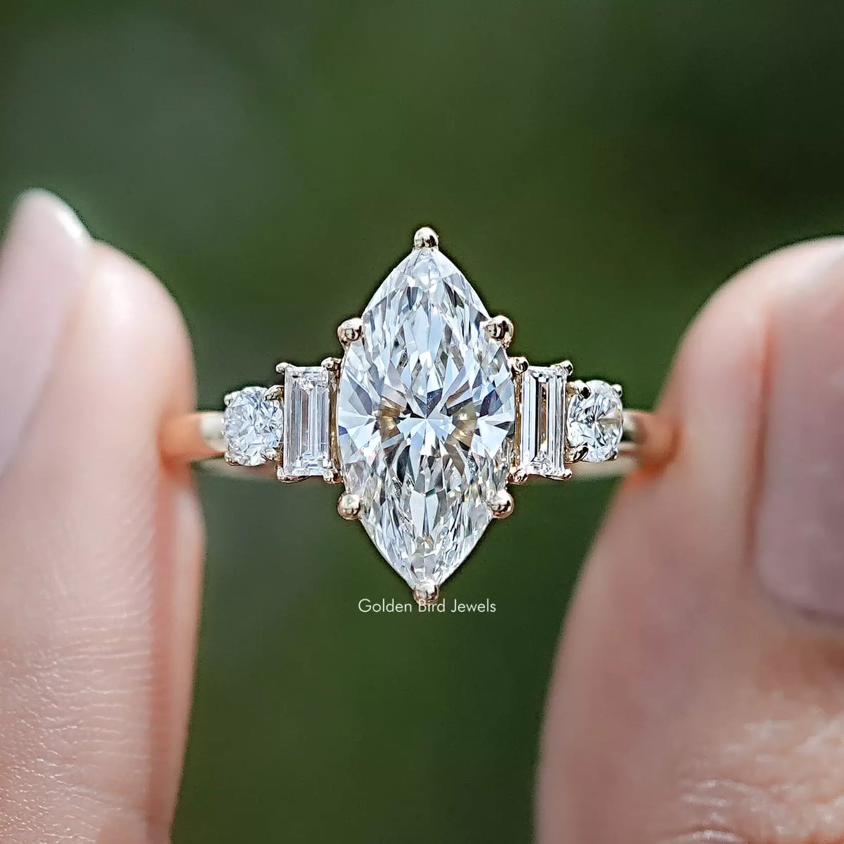 Marquise And Baguette Lab Diamond Five Stone Ring Between Two Fingers
