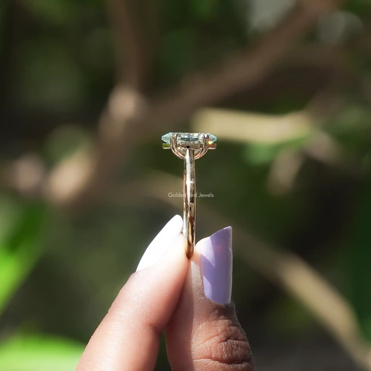 Side view of Blue marquise moissanite halo ring