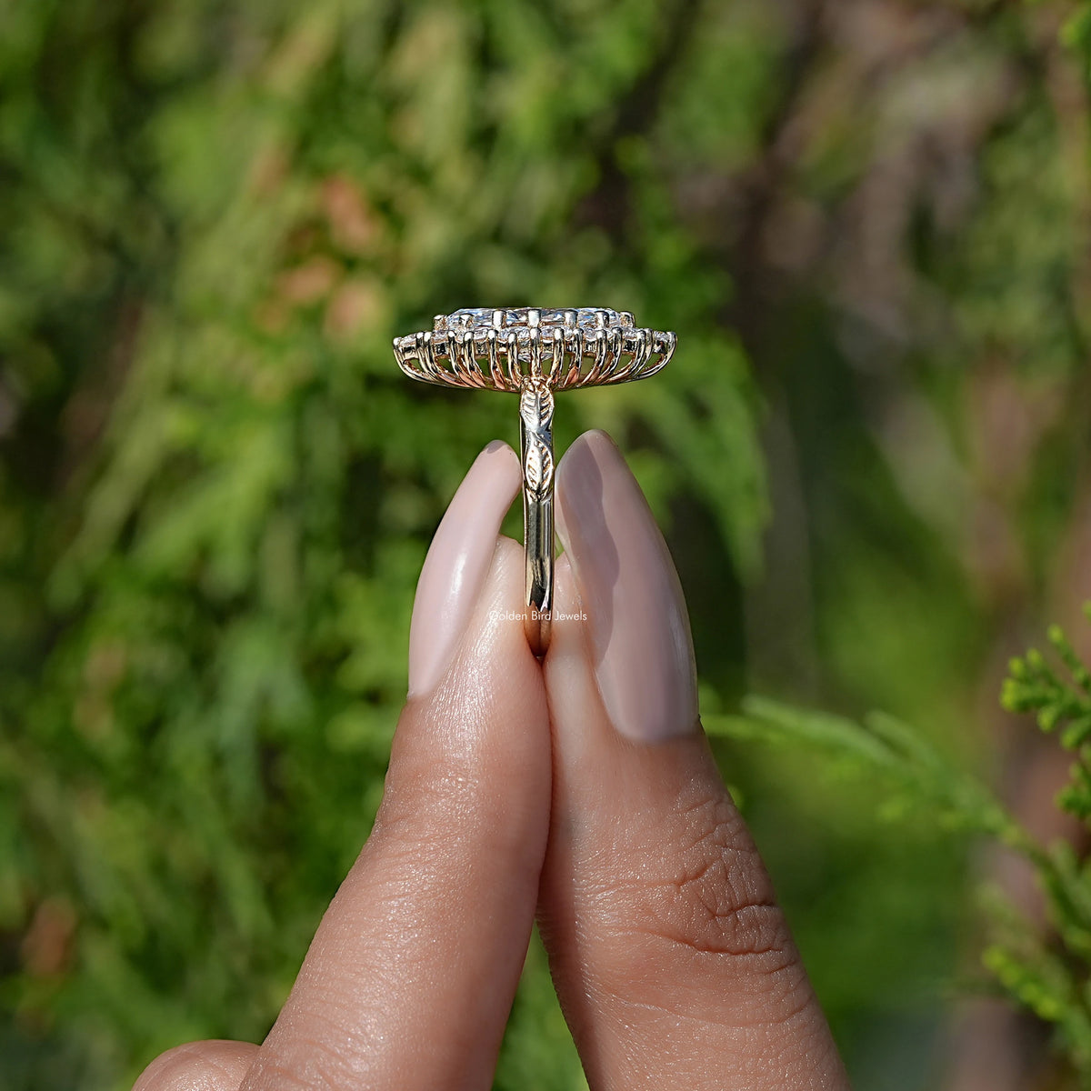 Side View of Marquise Cut Lab Diamond Halo Engagement Ring In two fingers