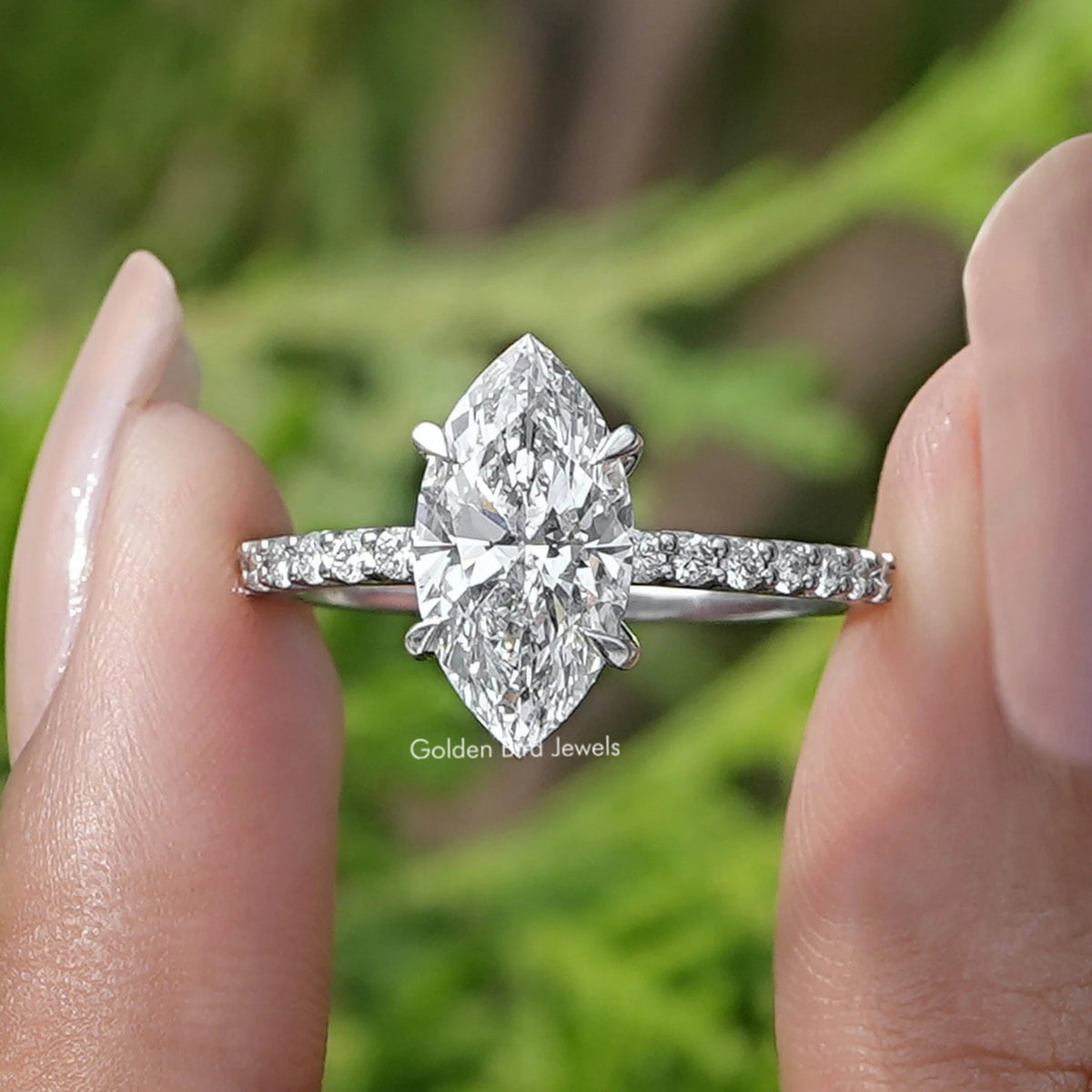 Front View of Marquise Cut Diamond Solitaire Ring In two fingers