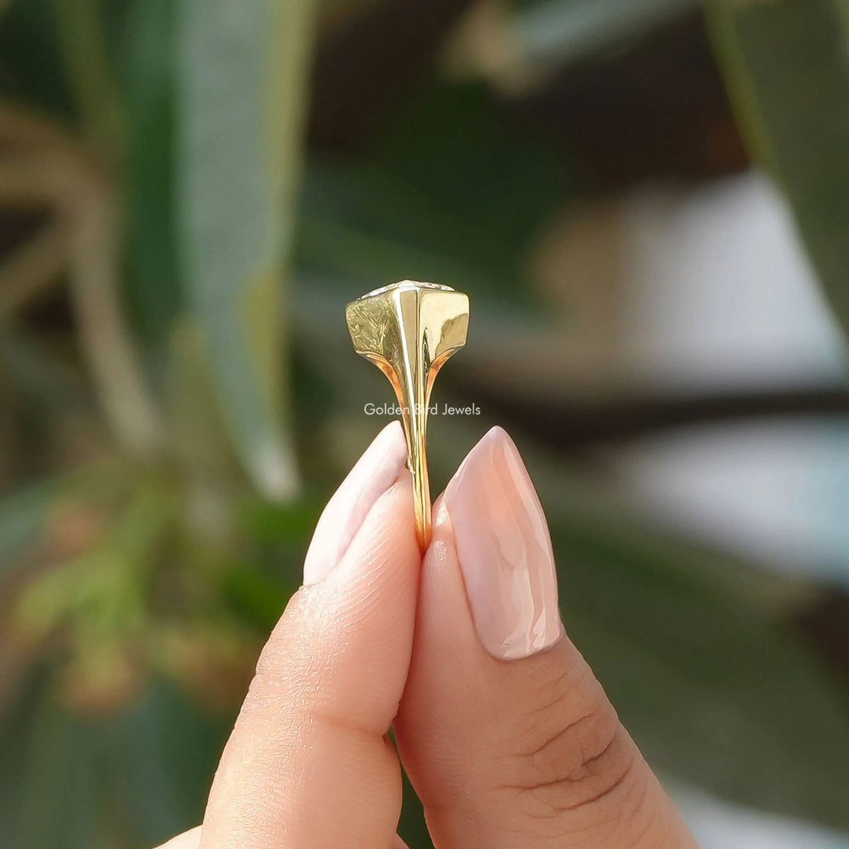 Side View of Lozenge Cut Moissanite Ring In two fingers