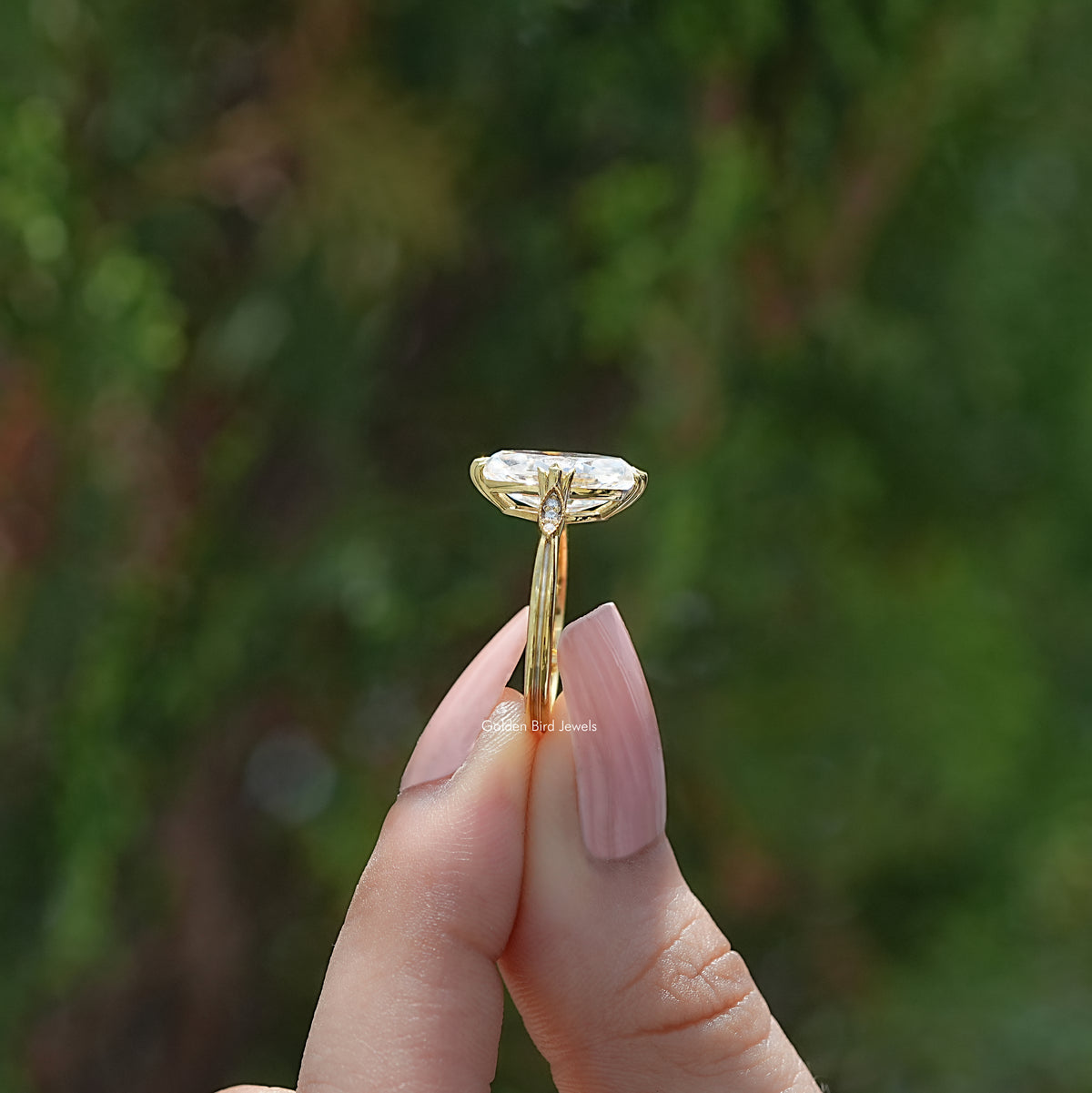 Marquise moissanite ring shown edge-on, with a raised setting and narrow band