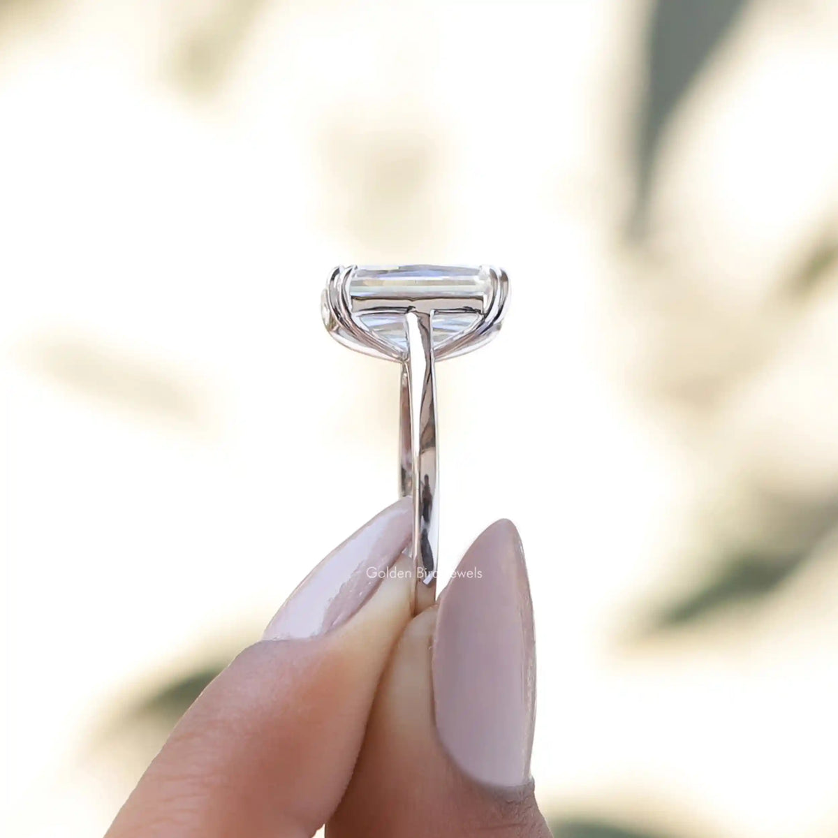 Side View of Criss Cut Solitaire Engagement Ring In two fingers