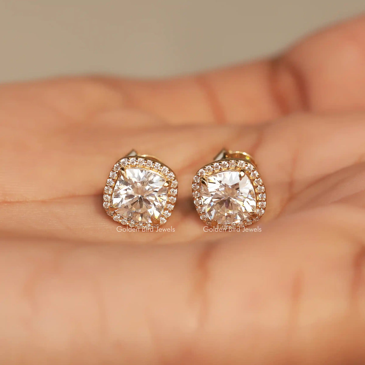In Hand View Of cushion cut moissanite stud Earring