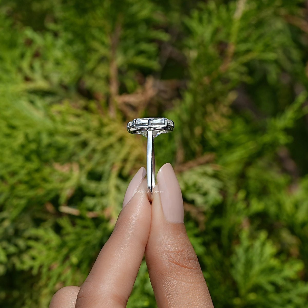 Side View of Moissanite Elongated Old Mine Cushion Cut Ring In two fingers