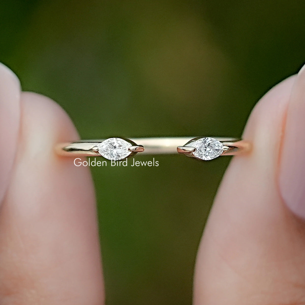 Marquise Cut Lab Diamond Open Cuff Two Stone Ring Held Between Fingers