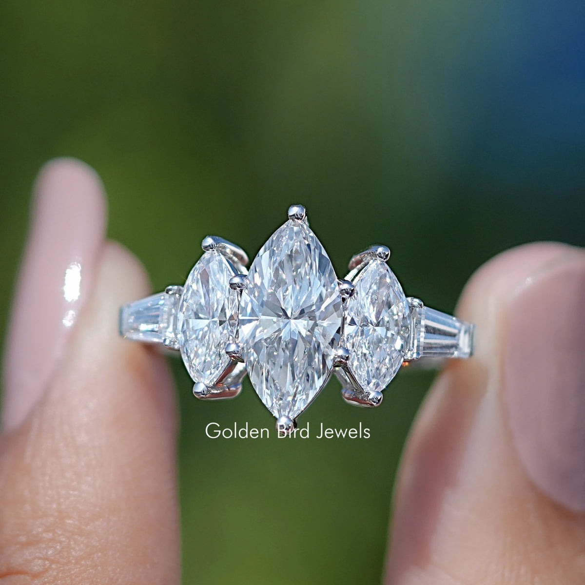 Marquise Lab Grown Diamond Five Stone Ring Held Between Fingers