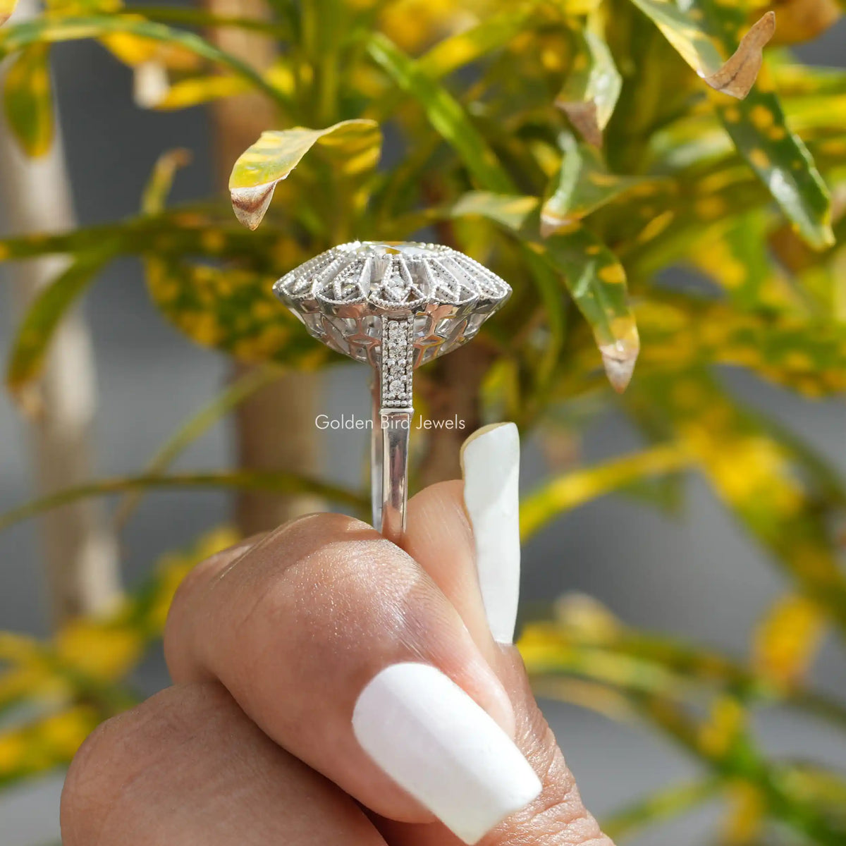 Side View of OEC Round Cut Moissanite Vintage Engagement Ring In two fingers