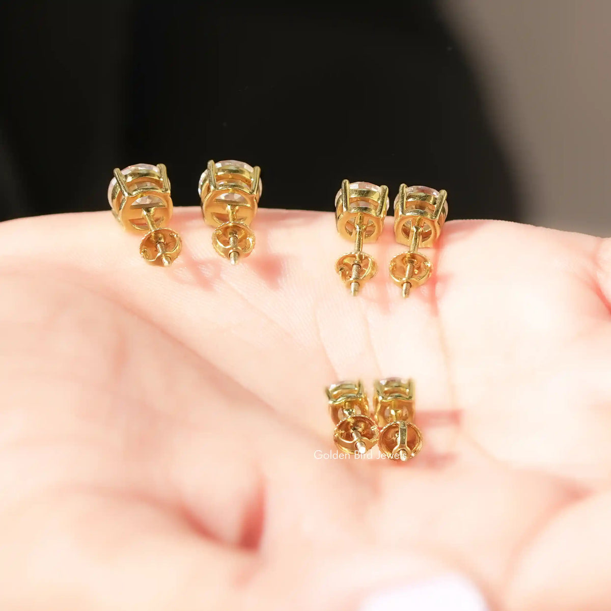 Back View Of Round European Cut Moissanite Stone earrings in a secure setting