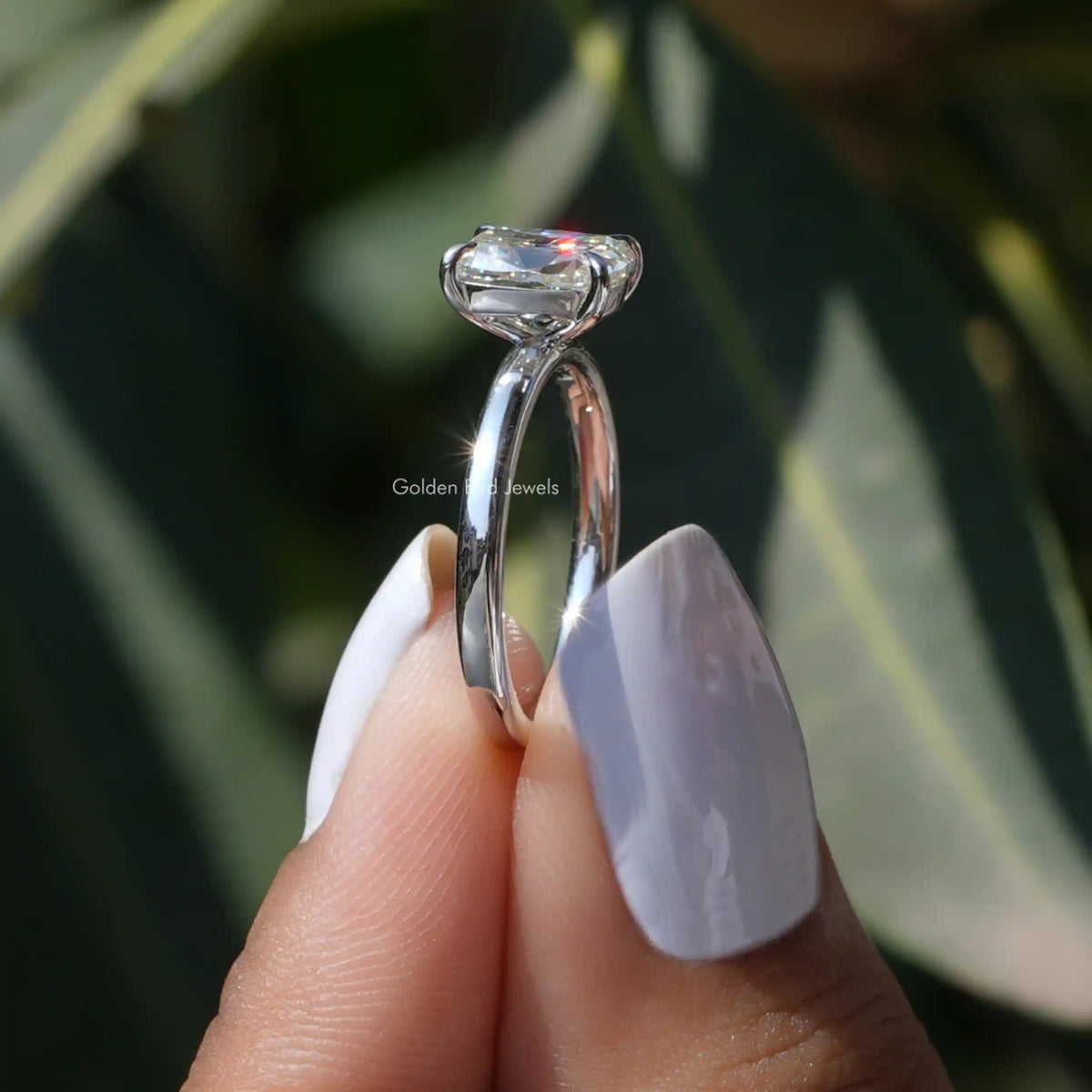Side View of Cushion Cut Moissanite Solitaire Ring In two fingers