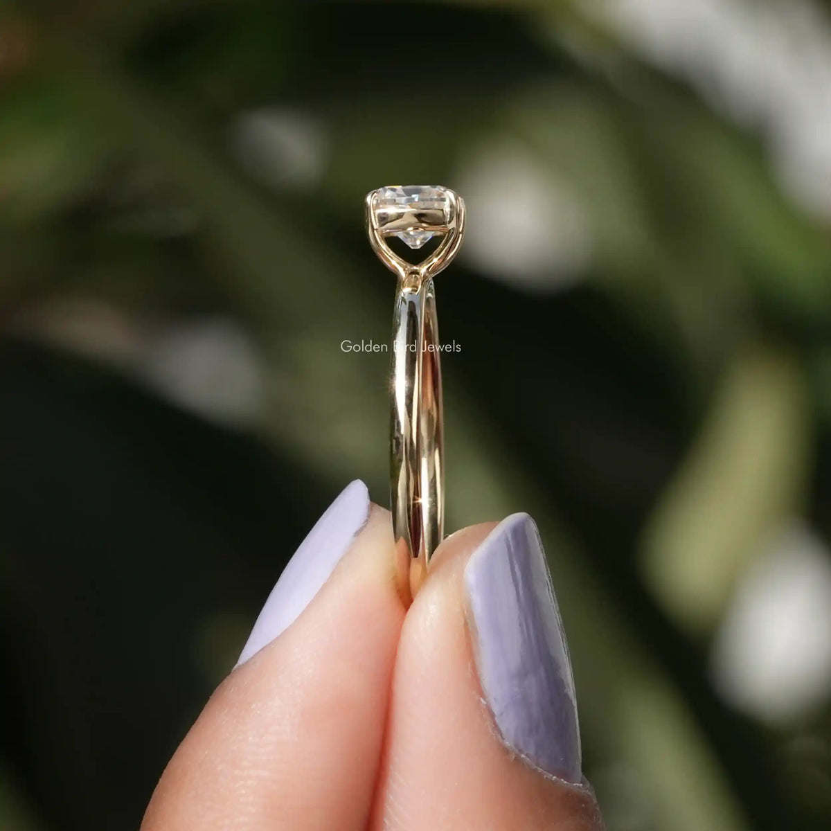 Side View of Cushion Cut Moissanite Ring In two fingers