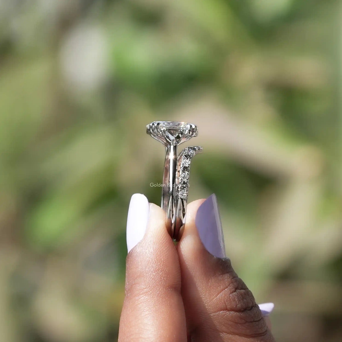 Side View of Oval Cut Lab Grown Diamond Ring In two fingers