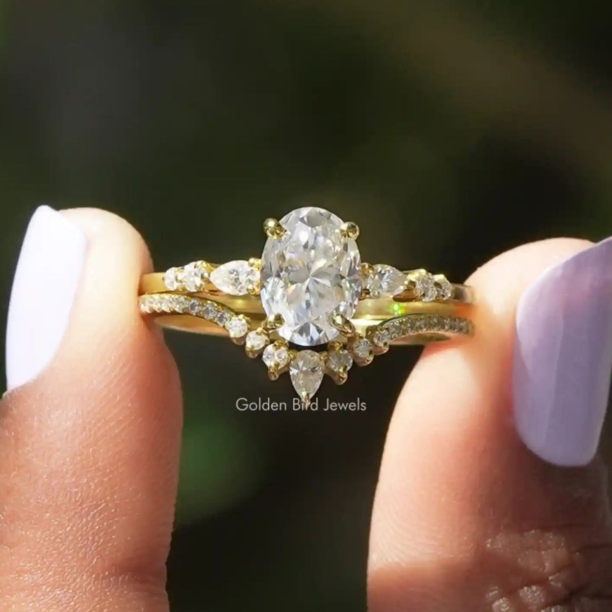 Two fingers holding the Oval Cut Accent Stone Ring