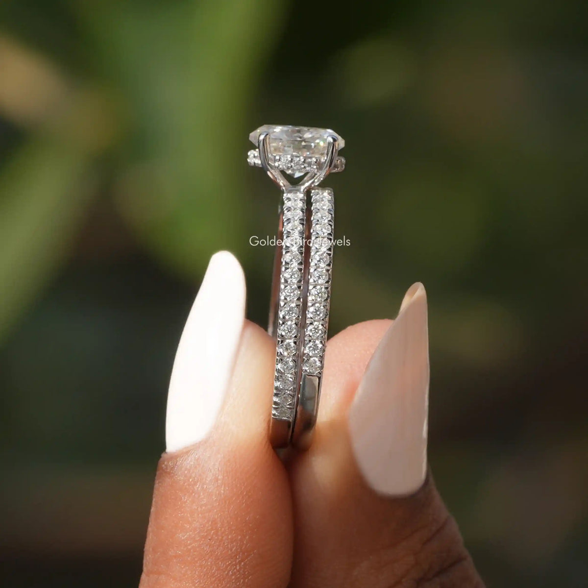 Side View of Oval Cut Moissanite Ring In two fingers