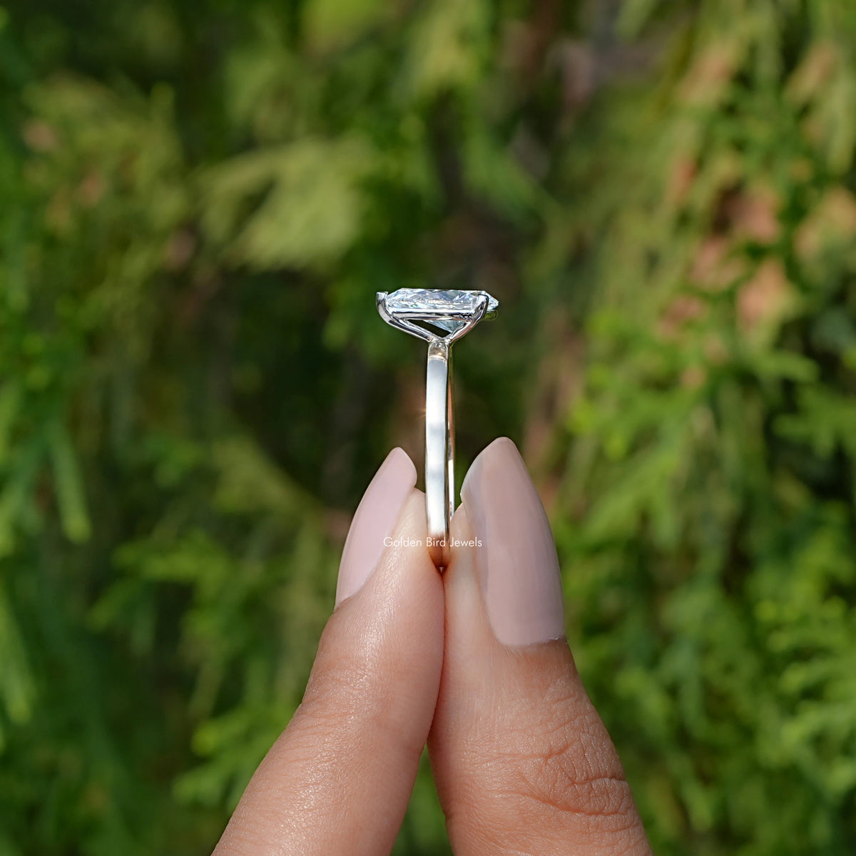 Side View of Pear Cut Lab Diamond Solitaire Ring In two fingers
