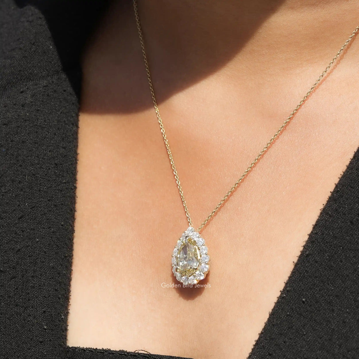 In neck view of Pear cluster moissanite halo pendant