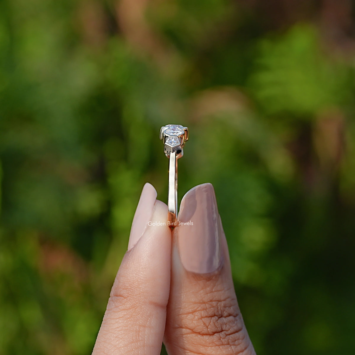 Side View of Round Cut Lab Grown Diamond Ring In two fingers