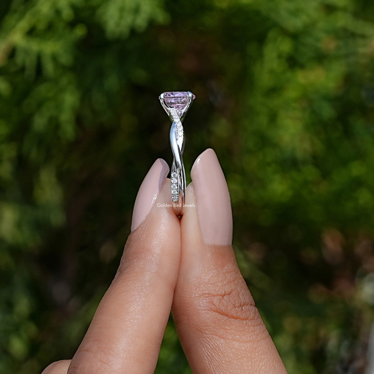 Side View of Pink Tourmaline Round Gemstone Ring In two fingers