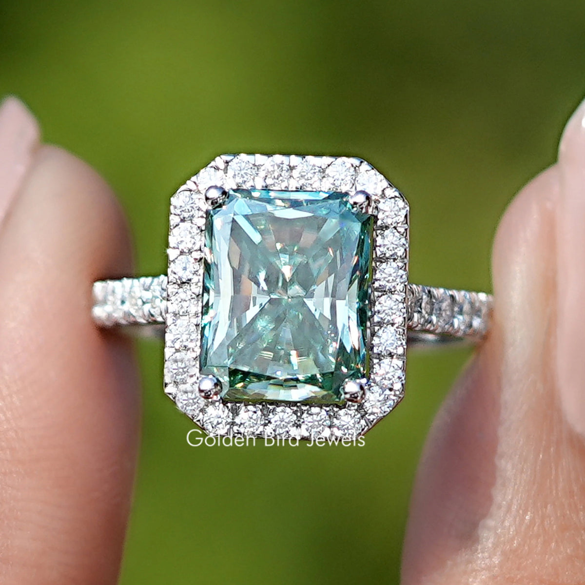 Front view of Blue Green Radiant Cut Moissanite Halo Accents Ring
