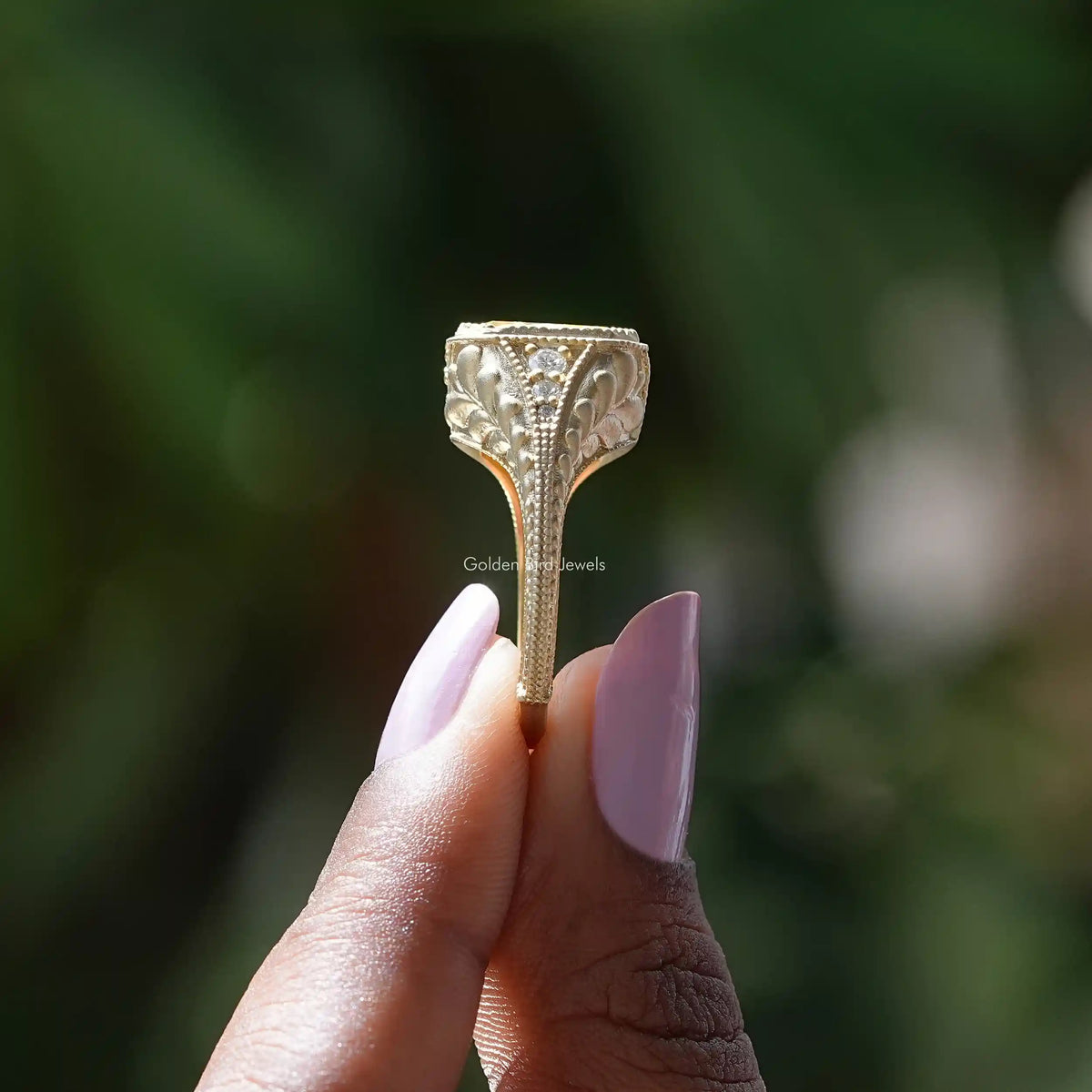 Side View of Radiant Cut Milgrain Accent Stone Ring In two fingers