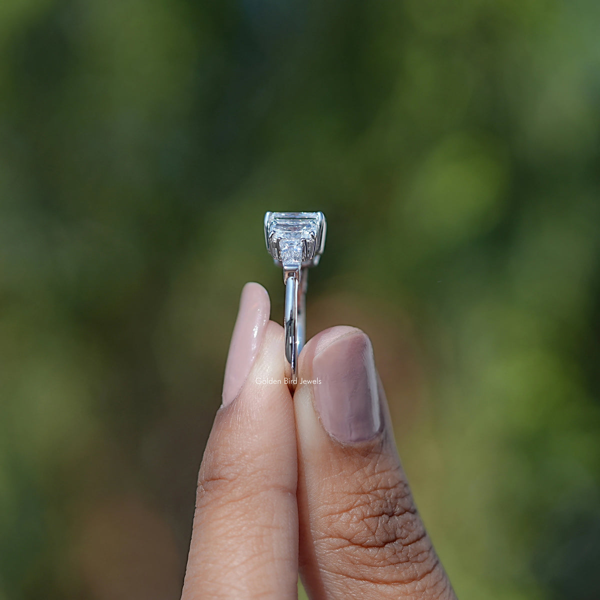 Side View of Radiant Cut Lab Diamond Five Stone Ring In two fingers