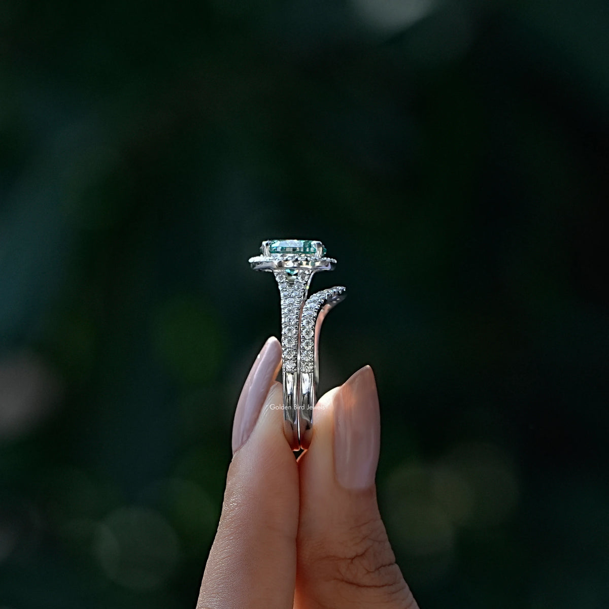 Side View of Round And Oval Cut Bridal Ring Set In two fingers