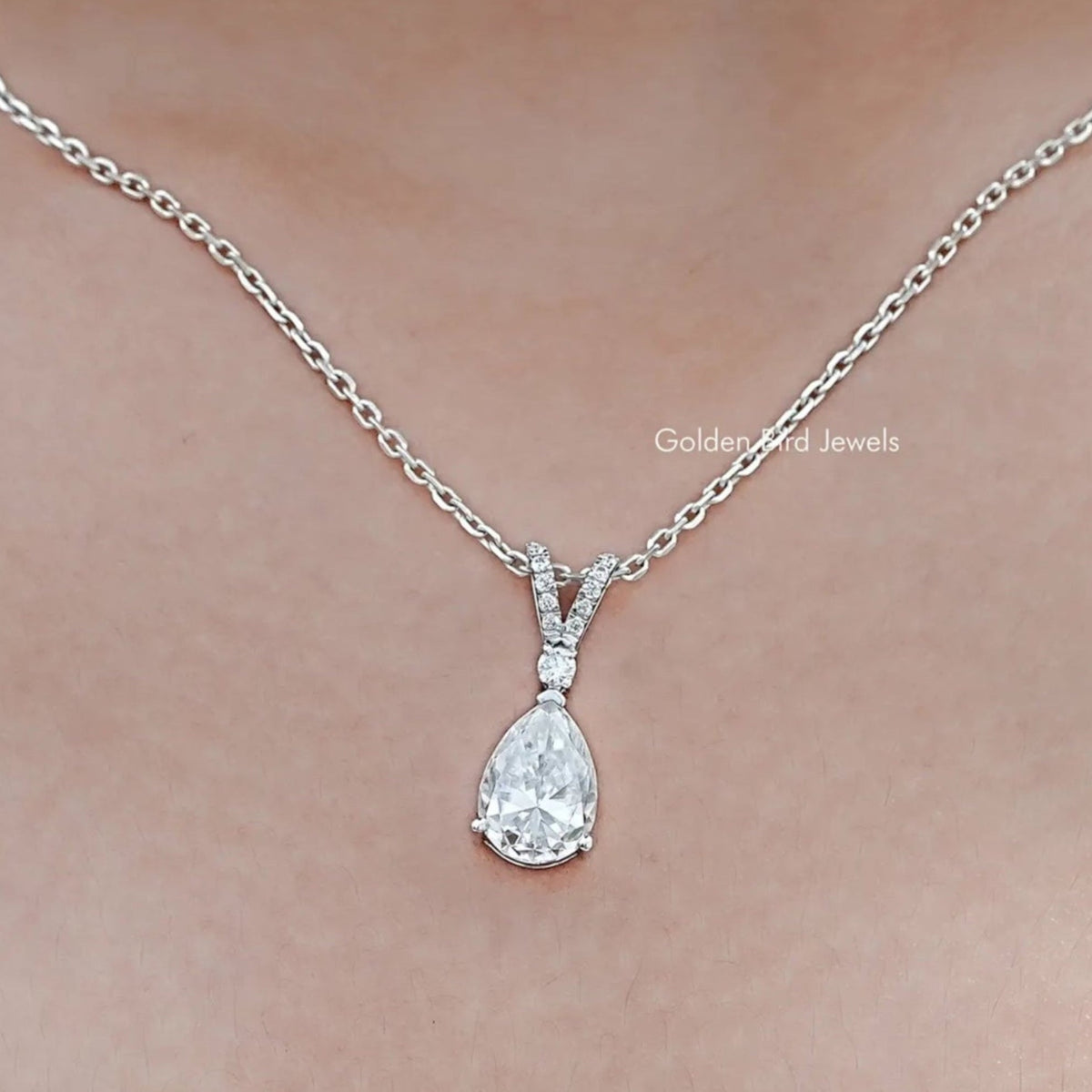 In neck View Of Round And Pear Cut Moissanite Tear Drop Pendant