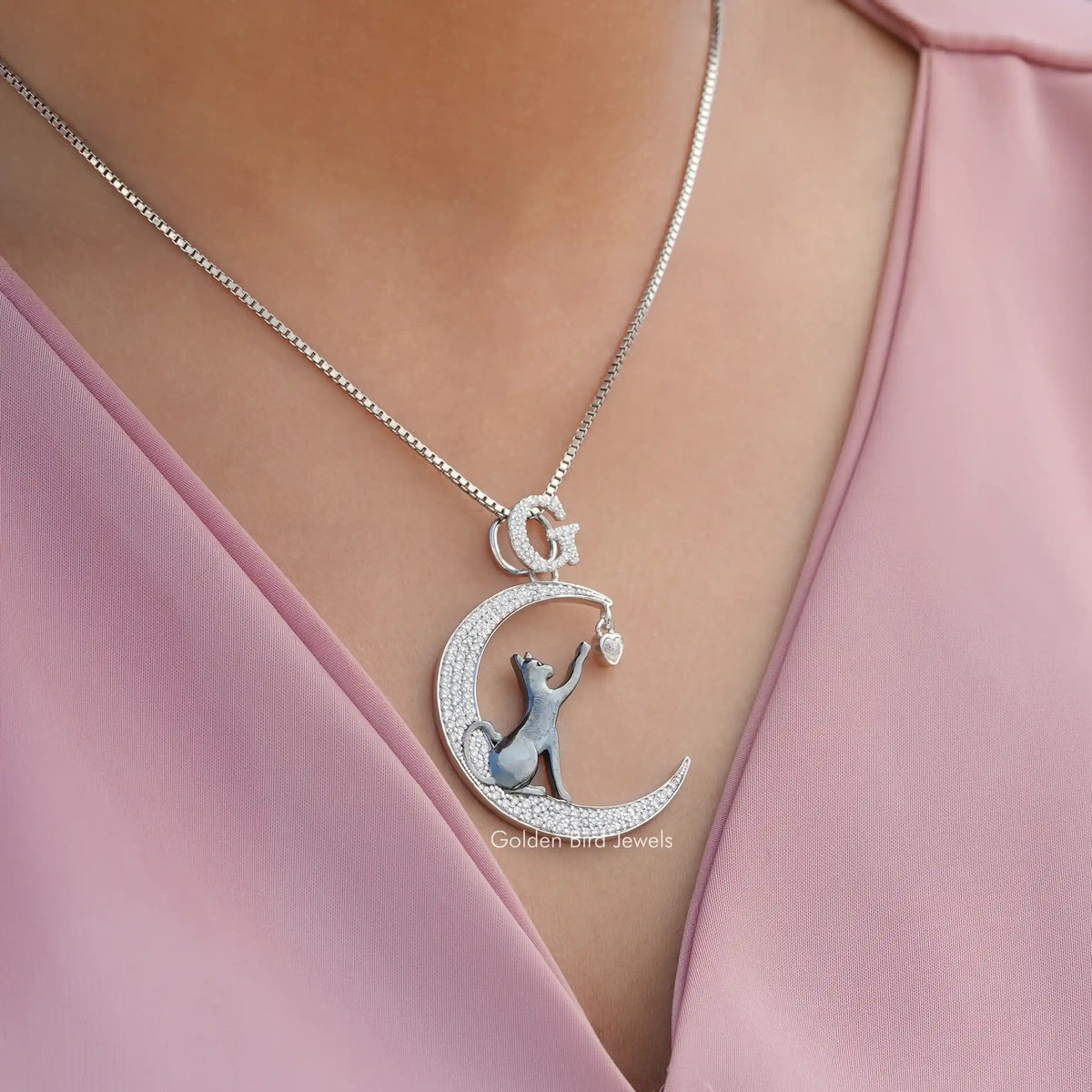 In neck view of round cut cat moon moissanite halo pendant
