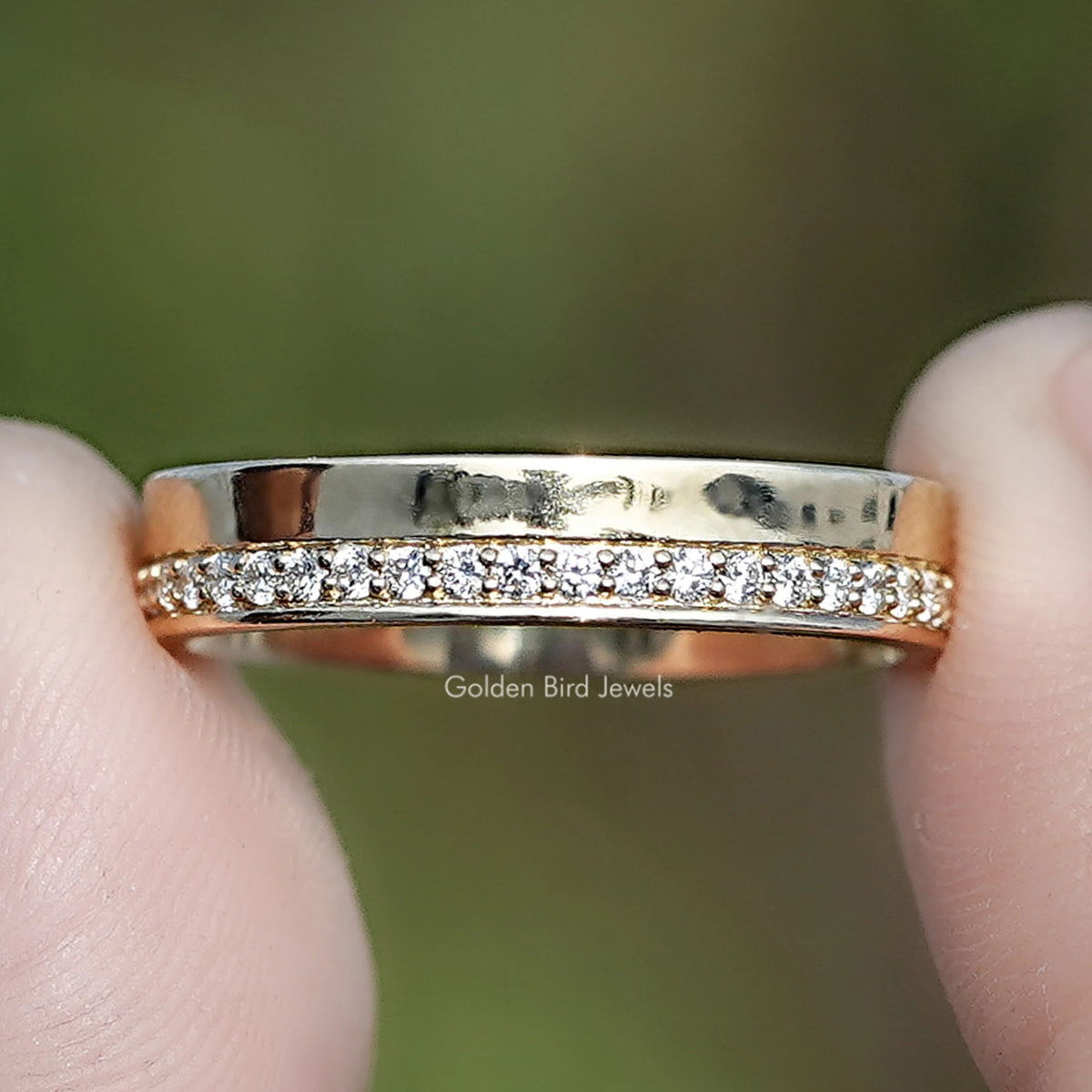 Round Shape Lab Diamond Wedding Ring Held Between Fingers