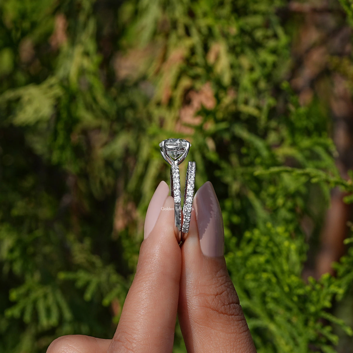 Side View of A Round Cut Lab Grown Diamond Wedding Ring In two fingers