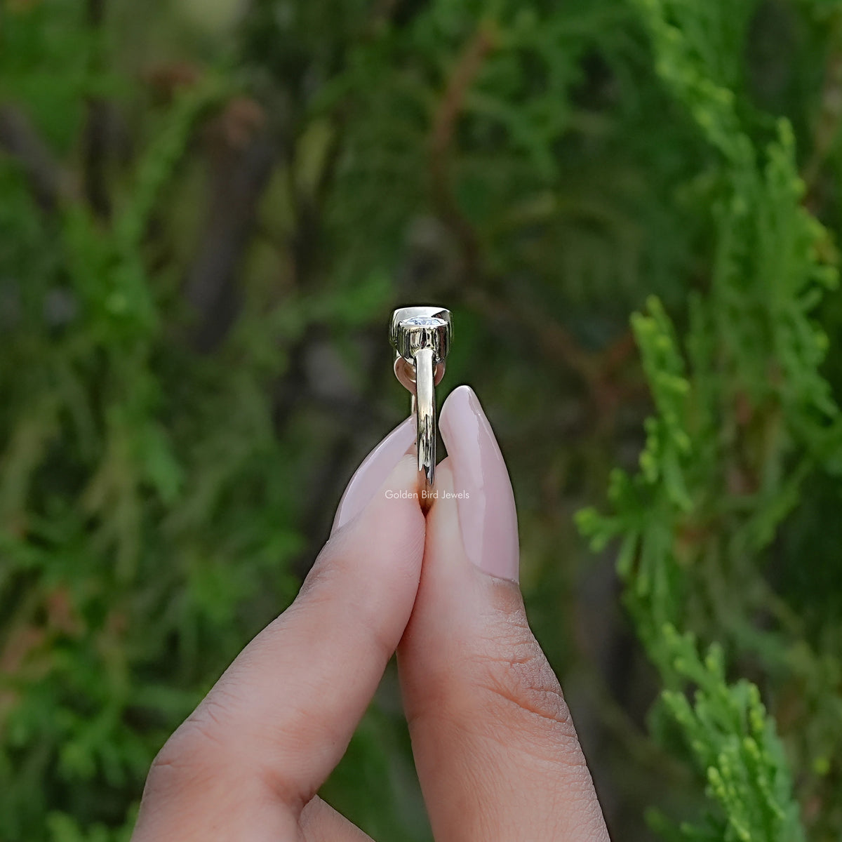 Side View of Round Moissanite Three Stone Bezel Set Ring